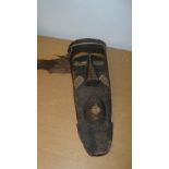 A Bashongo wooden mask, 55cm (21.5 in) high, an Asmat wooden bowl or ladle, 36cm (14 in) wide,