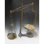 A large set of brass scales and a 19th century set of mahogany and brass scales, each with weights