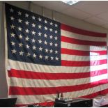 A 48 star American flag, 241 x 140cm, a quantity of American college flags and a leather ''