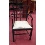 A 19th century ebonised elbow chair, 96cm high