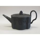 A black basalt tea pot and cover together with a white jug moulded with Bacchic putti