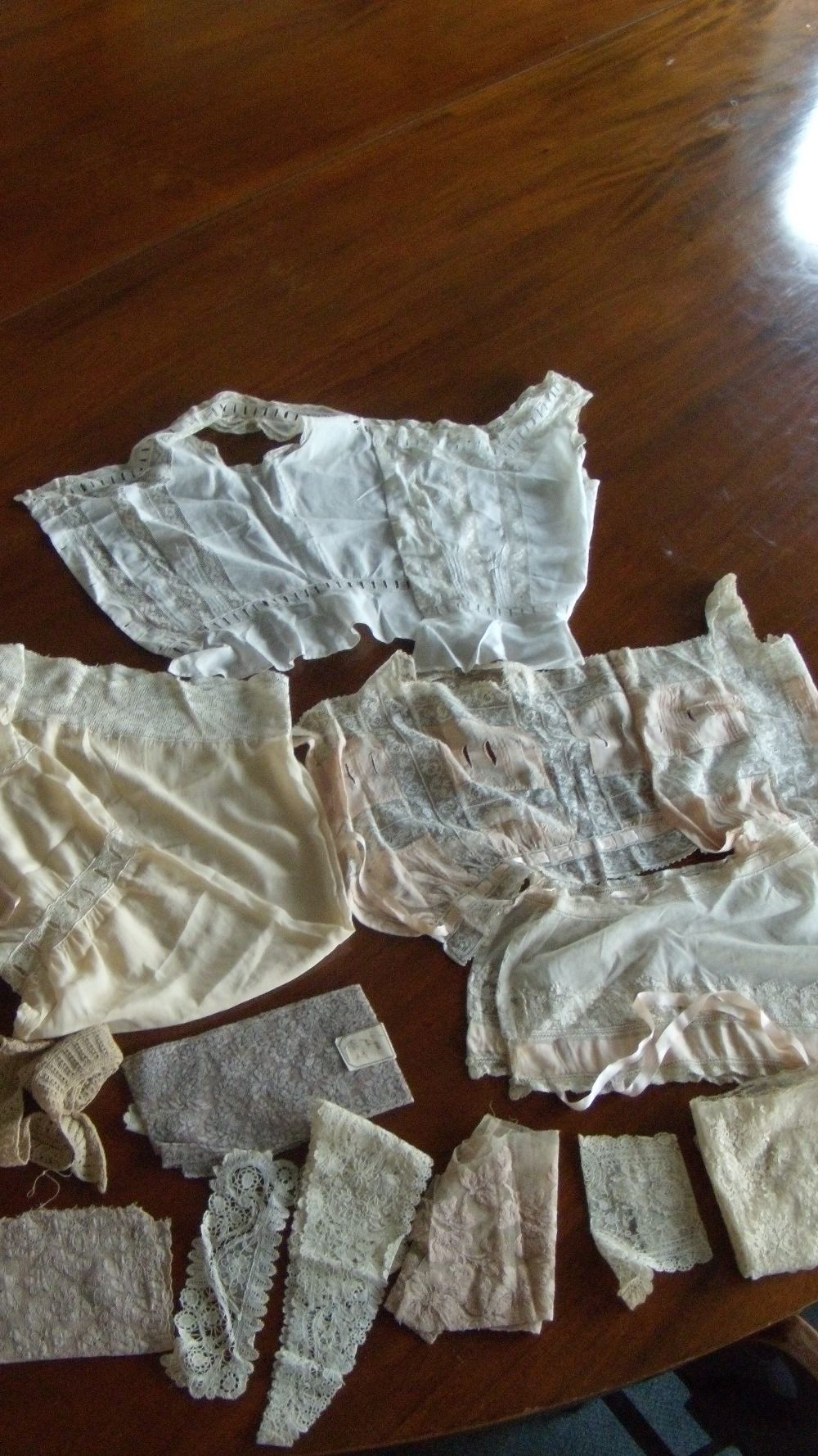 Three lace trimmed bodices, a pair of drawers and miscellaneous lace