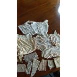 Three lace trimmed bodices, a pair of drawers and miscellaneous lace