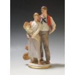 An early 20th century German porcelain figure group of a pair of young lovers, in country clothes,