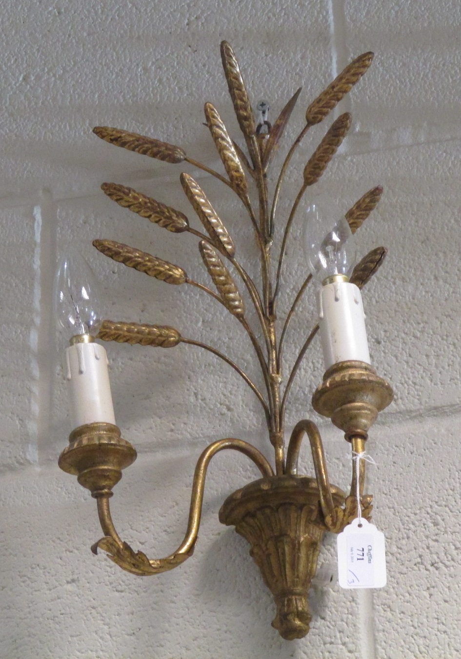 A set of three gilt wall lights