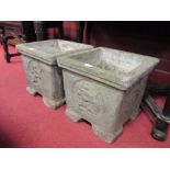 A pair of reconstituted stone garden urns, together with a pair of terracotta wall pockets.