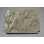 A Chinese green stone plaque carved in relief with a dragon, 7.25 x 5cm