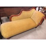 A Victorian mahogany framed chaise longue on turned and fluted and castors