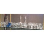 Three decanters and a quantity of drinking glasses