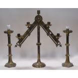 A large adjustable brass ecclesiastical candelabra and a pair of brass gothic style column