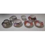 A New Hall 'Boy at the Window' tea cup and three saucers, a 1318 pattern coffee cup and saucer, a
