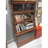 A Globe Wernicke four tier oak sectional bookcase and a pine blanket box