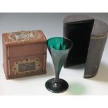 A leather and brass casket together with a single leather cased green wine glass (2)