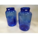 A pair of blue glass jars