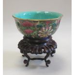 A 19th century Canton bowl with wood stand, the interior of the quatrefoil shape turquoise, the