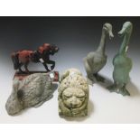 Three bronze garden ducks, a stone lion and a cast iron horse doorstop