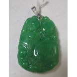 A Chinese green jadeite pendant carved with a boy and giant gourd