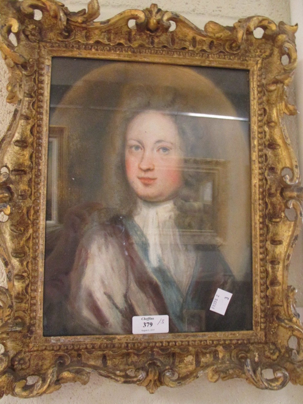 Portrait of a gentleman in a gilt frame, pastel, together with two framed watercolours of crests (3)
