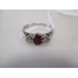 A three stone ruby and diamond ring, all set in 18ct white gold hallmarked Birmingham 1985