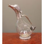 A modern electroplate claret jug modelled as a duck with clear glass body, the head hinged at the