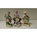 A pair of and a single Derby seated figure, 13cm (5 in) high (3)  She has had restoration to both