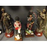 A 20th century porcelain figure of a Highland Bagpiper by David Fryer and another, and a pair of