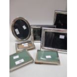 A collection of silver photograph frames