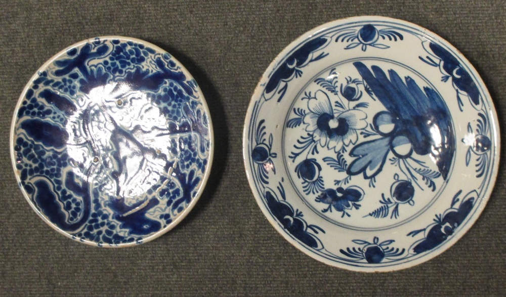 An 18th century English Delft blue and white plate together with a plate painted with a lion (2)