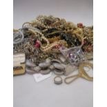 A large quantity of costume jewellery to include diamante, faux pearls, gilt chains etc