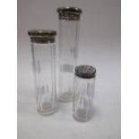 Three silver topped glass scetn bottles (one damaged)