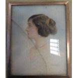 An early 20th century portrait miniature of a lady with brown hair, white dress and wearing pearl