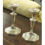 A pair of silver candlesticks, loaded