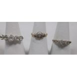 An 18ct three stone illusion set ring, an 18ct white hardstone ring and a small 18ct diamond ring,