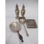 Two silver tea strainers, cigarette case, and a pair of peppers