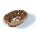 An early 19th century paper filigree basket, with central floral motif and looped handle to one end,