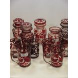 A collection of Bohemian ruby overlay glass, four beakers, two mugs and six jars