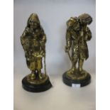 A pair of early 20th century brass figures of a peasant stitch corrain and his wife, 30cm high