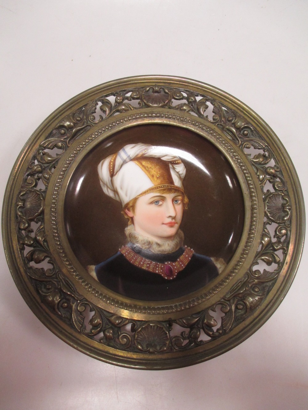 A German painted porcelain dish in a bronze frame