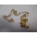 An 18ct gold teddy bear pendant (adapted from a brooch, 16g) on a later chain indistinclty stamped