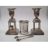 A Continental beaker, sugar nips and a pair of plated shaped loaded-base candlesticks