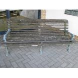 A cast iron garden bench with faux branch work frame