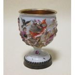 A Continental porcelain relief decorated goblet