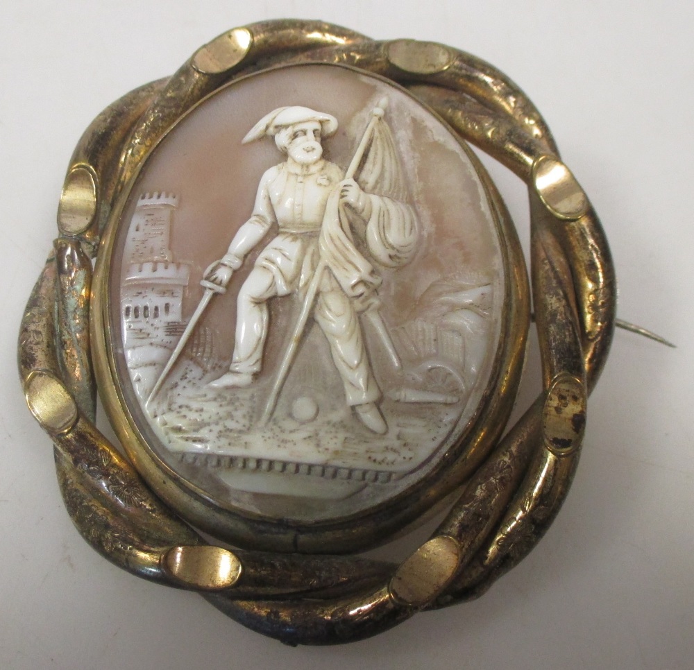 A shell cameo brooch of a 19th century soldier with the city beyond, in yellow metal mount, 7cm