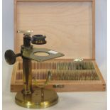 A Baker of London microscope together with a box of microscope slides