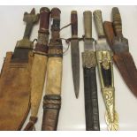 Two .800 standard silver knives with scabbards together with five other knives