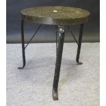 A pierced brass trivet/table on three iron legs