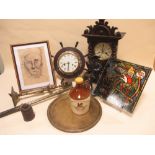 A coloured glass panel together with a brass and wood clock in the shape of a ship's wheel, fire