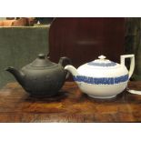 A Wedgwood basaltware tea pot and another with blue sprigging on white (2)