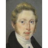 A collection of four portrait miniatures, one of a Gentleman wearing blue velvet coat with a high