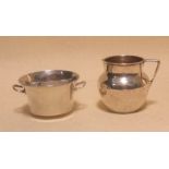 A silver circular sugar bowl, a milk jug and another bowl (3)